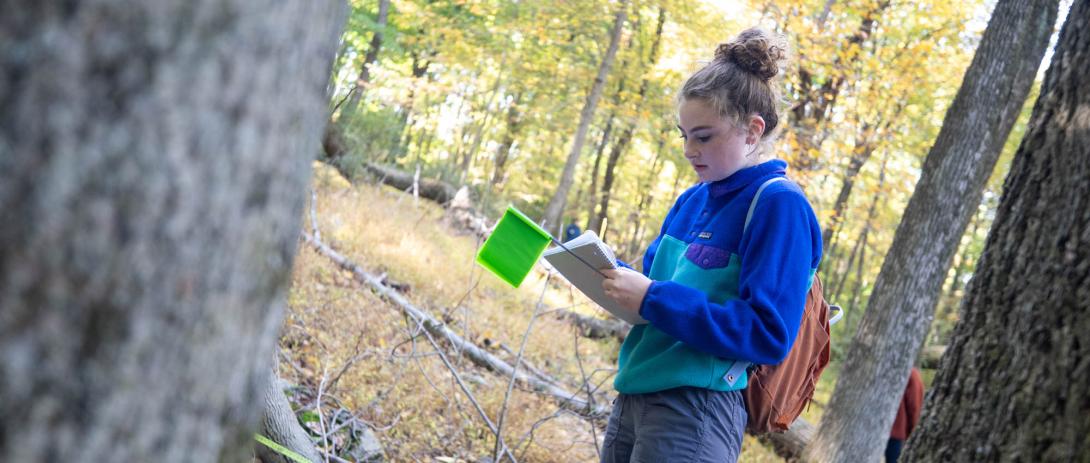 A student makes notes outside on South Mountain at Lehigh University